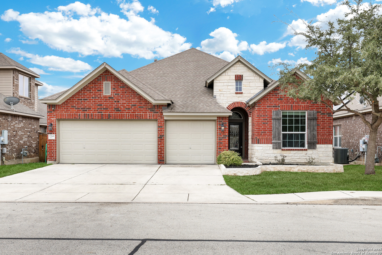 12246 Chambers Cove San Antonio, TX 78253 - Photo 1 of 1 a front view of a house with a yard and garage