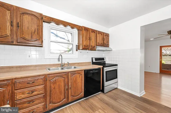 a large kitchen with stainless steel appliances granite countertop a stove and a sink