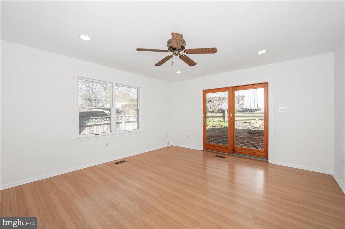 11852 Huggins Drive Silver Spring, MD 20902 - Photo 15 of 63 wooden floor in an empty room with a window