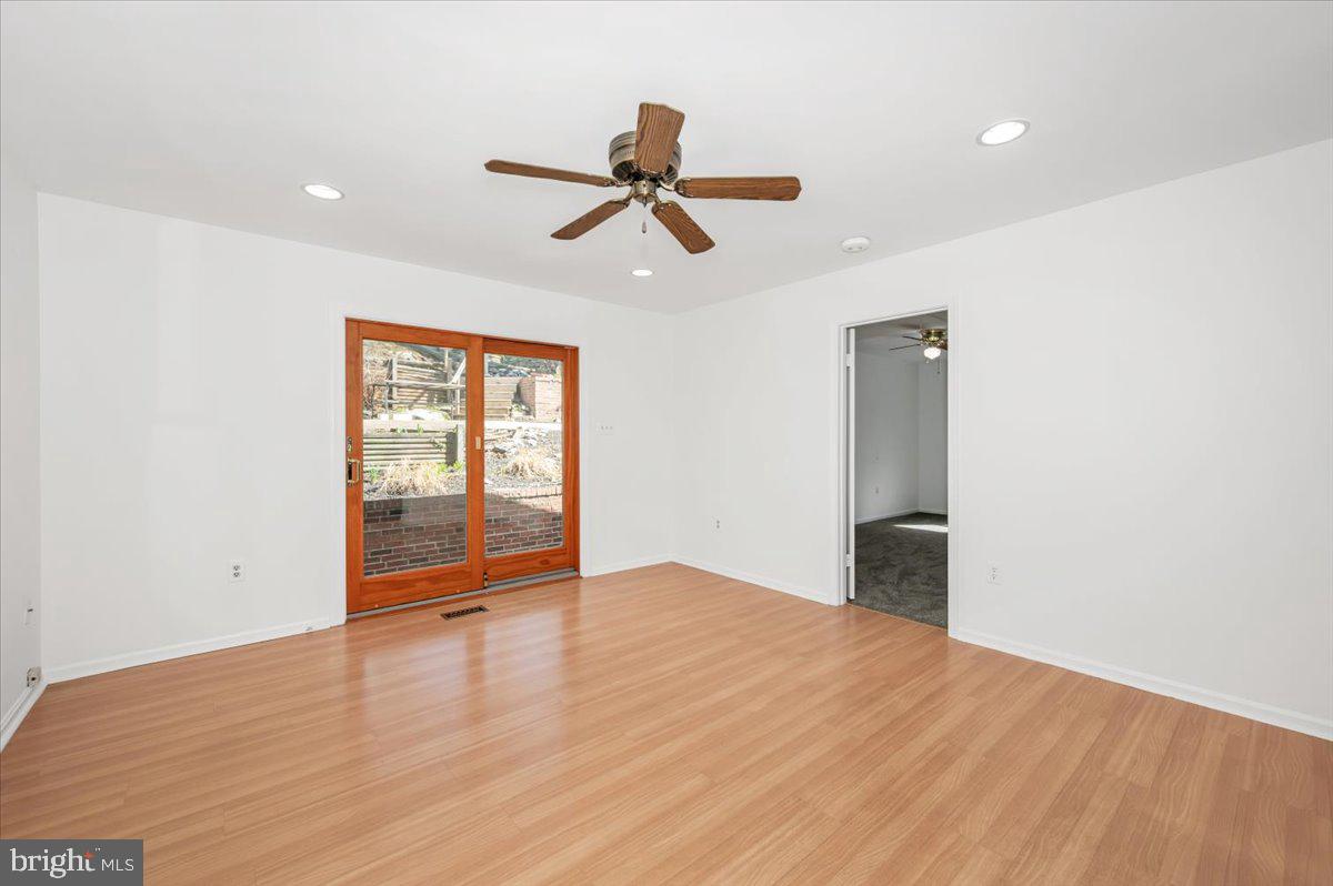 11852 Huggins Drive Silver Spring, MD 20902 - Photo 16 of 63 an empty room with wooden floor and windows