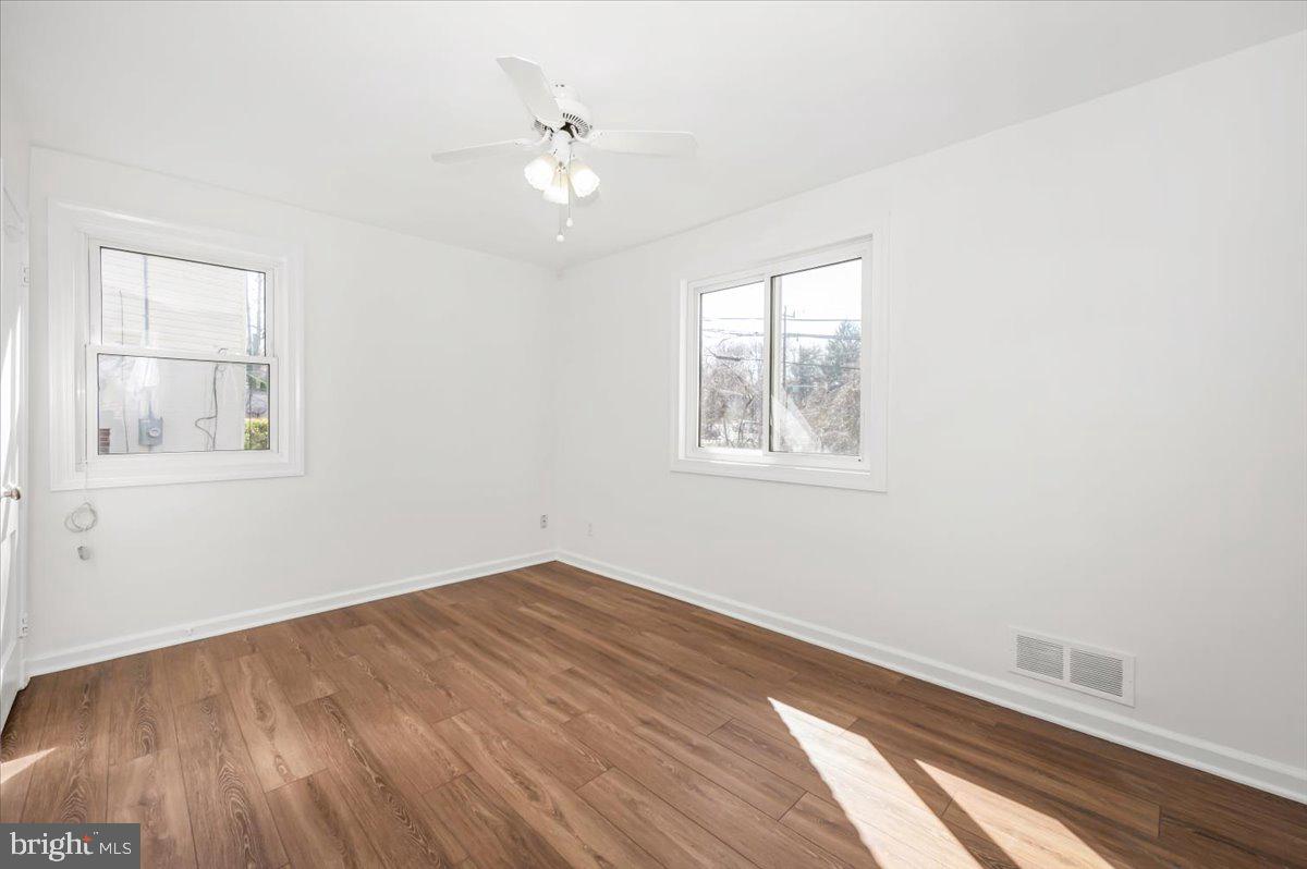 11852 Huggins Drive Silver Spring, MD 20902 - Photo 24 of 63 a view of a room with wooden floor and windows