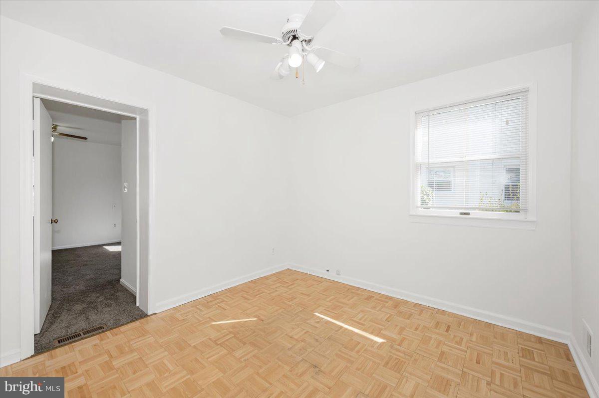 11852 Huggins Drive Silver Spring, MD 20902 - Photo 26 of 63 a view of a room with a ceiling fan and wooden floor