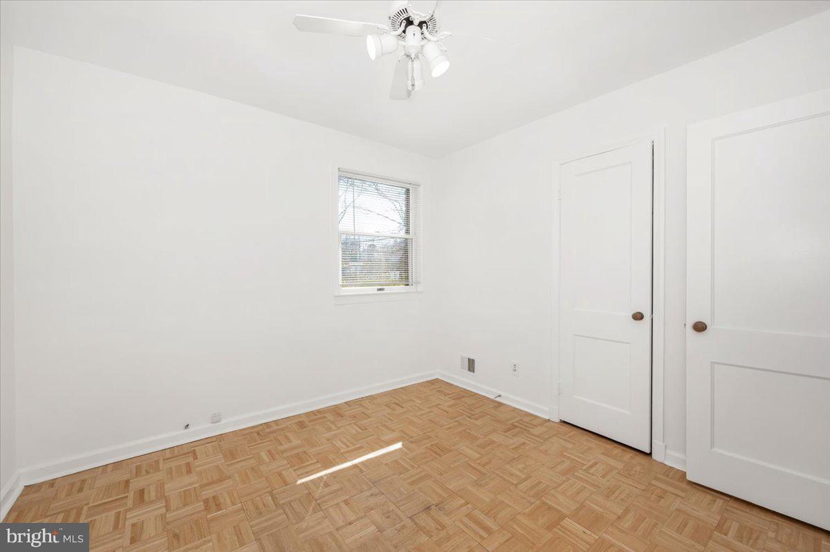 11852 Huggins Drive Silver Spring, MD 20902 - Photo 27 of 63 a view of a room with wooden floor and ceiling fan