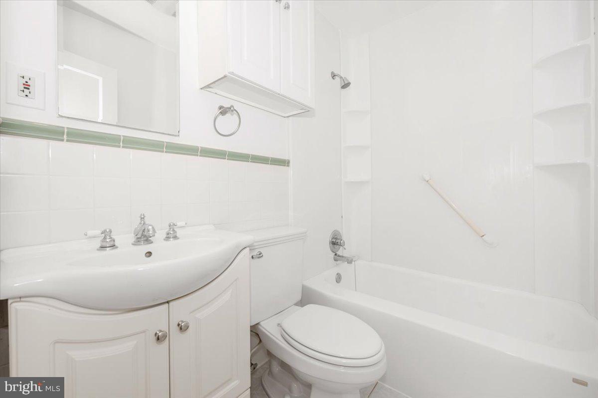 11852 Huggins Drive Silver Spring, MD 20902 - Photo 29 of 63 a bathroom with a sink a toilet and shower