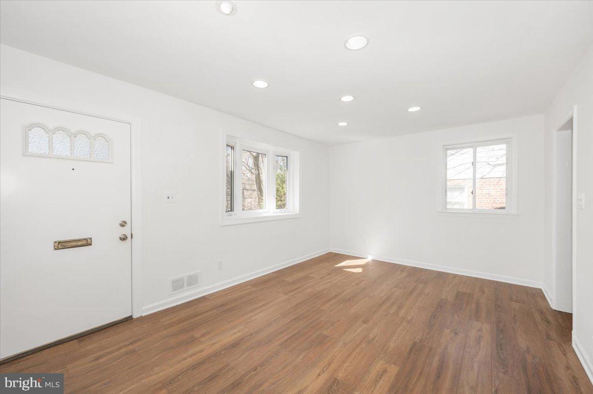 11852 Huggins Drive Silver Spring, MD 20902 - Photo 3 of 63 an empty room with wooden floor and windows