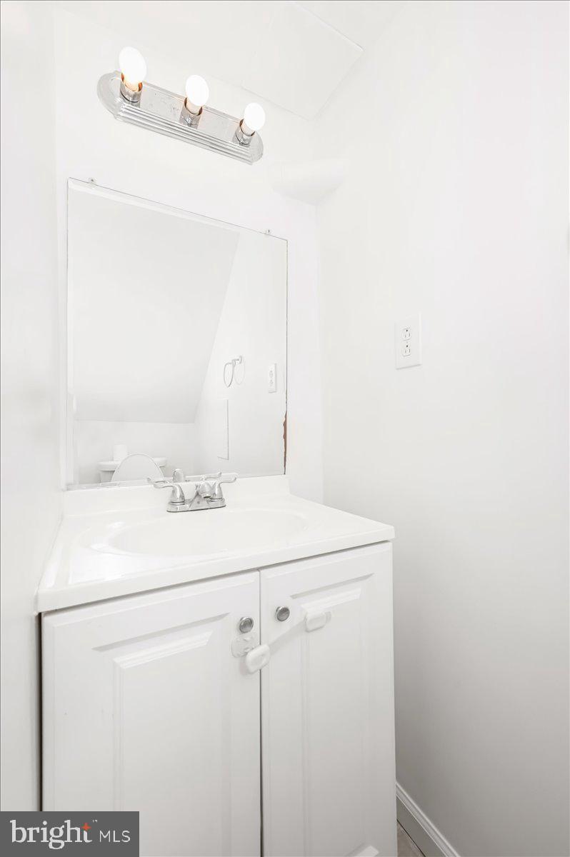 11852 Huggins Drive Silver Spring, MD 20902 - Photo 37 of 63 a bathroom with a sink and mirror
