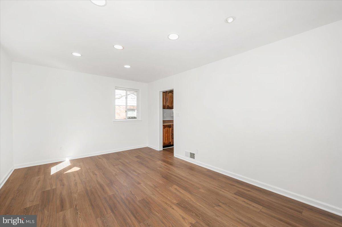 11852 Huggins Drive Silver Spring, MD 20902 - Photo 4 of 63 an empty room with wooden floor and window