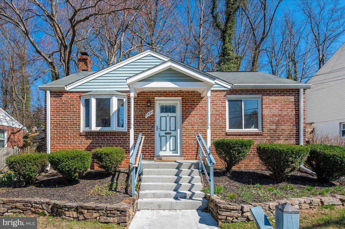 11852 Huggins Drive Silver Spring, MD 20902 - Photo 5 of 63 a front view of a house with garden