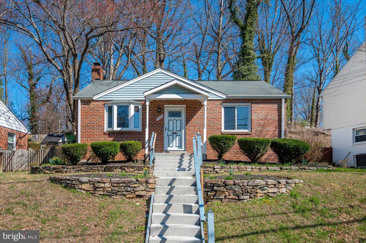 11852 Huggins Drive Silver Spring, MD 20902 - Photo 58 of 63 a front view of a house with a yard