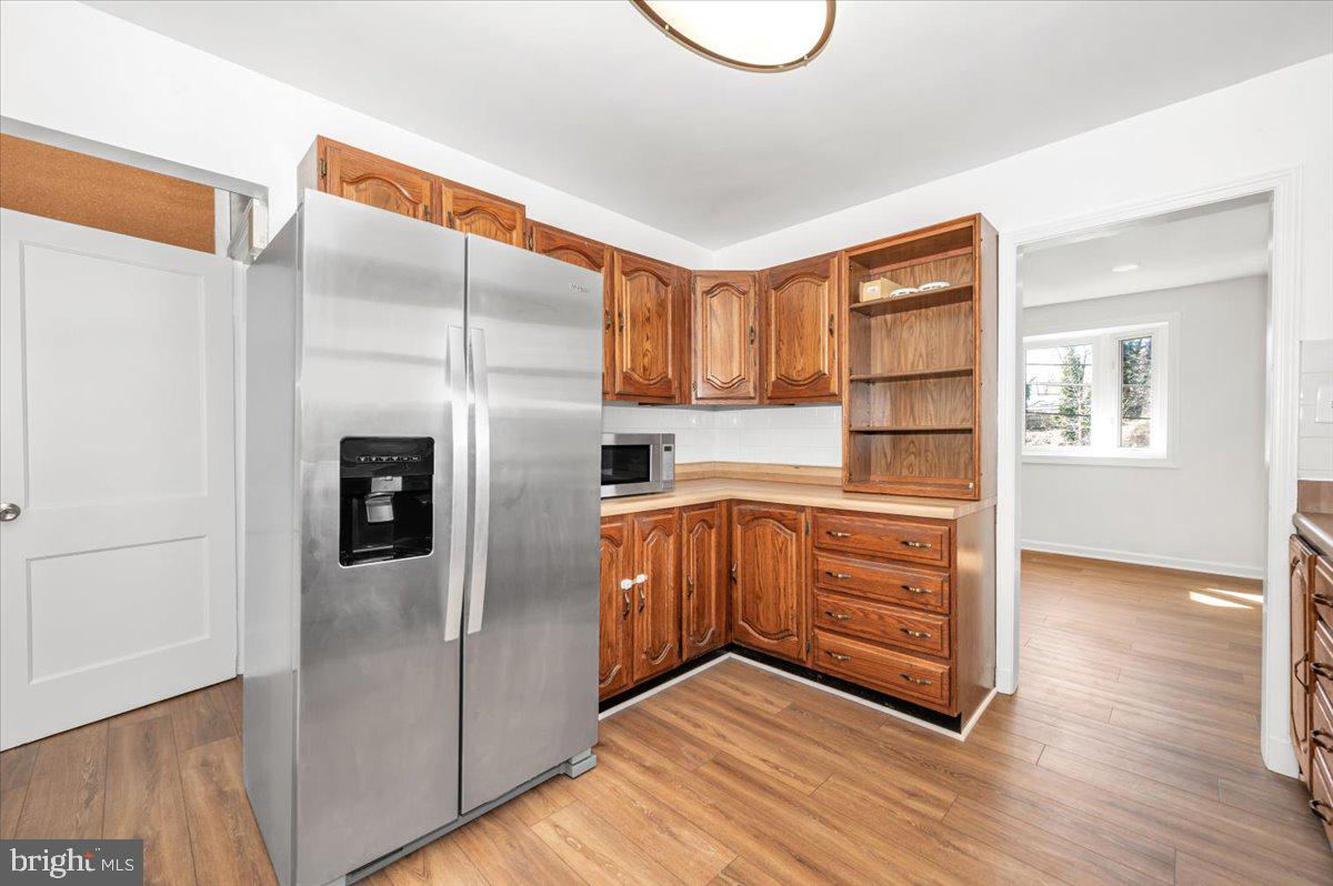 11852 Huggins Drive Silver Spring, MD 20902 - Photo 6 of 63 a kitchen with granite countertop a refrigerator and a stove top oven