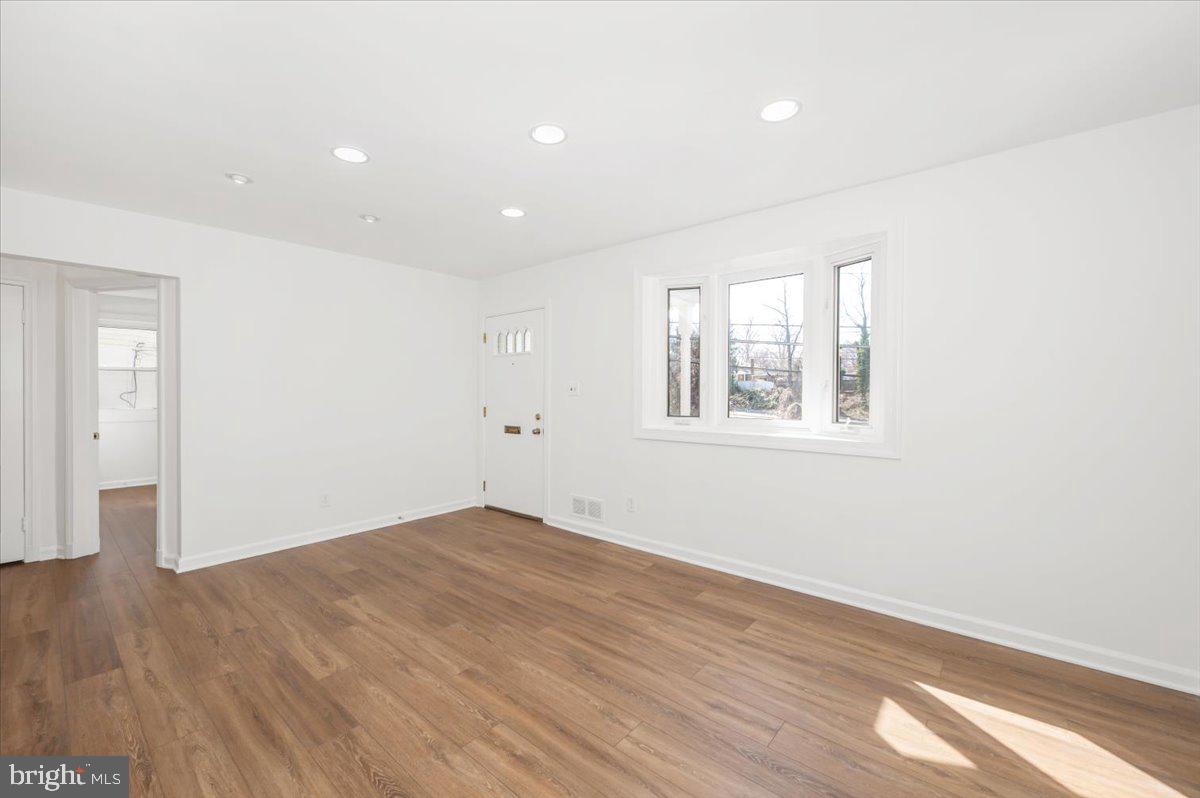 11852 Huggins Drive Silver Spring, MD 20902 - Photo 9 of 63 an empty room with wooden floor and windows