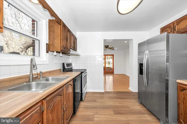 a kitchen with stainless steel appliances a stove microwave and cabinets