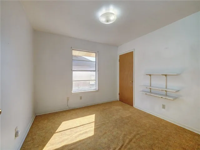 an empty room with a empty space and windows