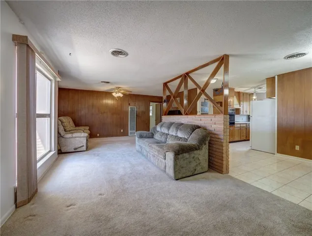 a living room with furniture and a ceiling fan