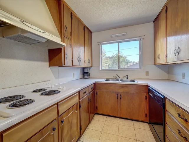 a kitchen with a refrigerator and a sink