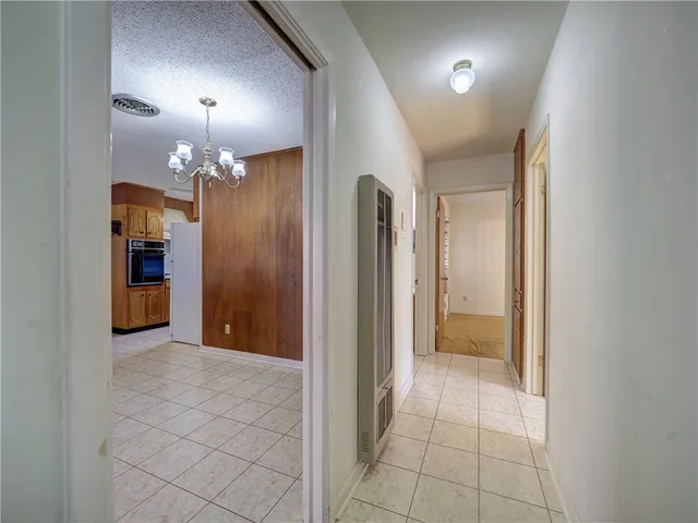 a view of a hallway with a chandelier