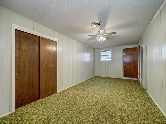 a view of a hallway with a chandelier fan