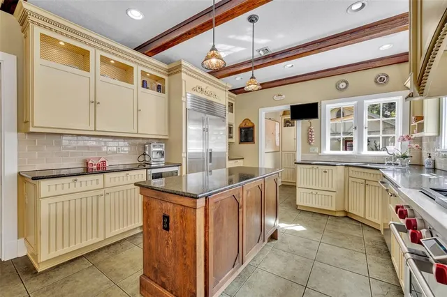 a kitchen with stainless steel appliances granite countertop a sink and cabinets