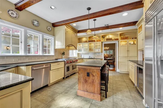 a kitchen with stainless steel appliances granite countertop a sink and cabinets