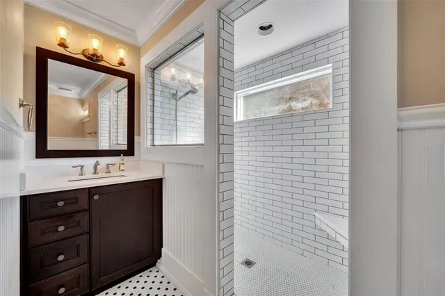 a bathroom with a sink a mirror and a shower