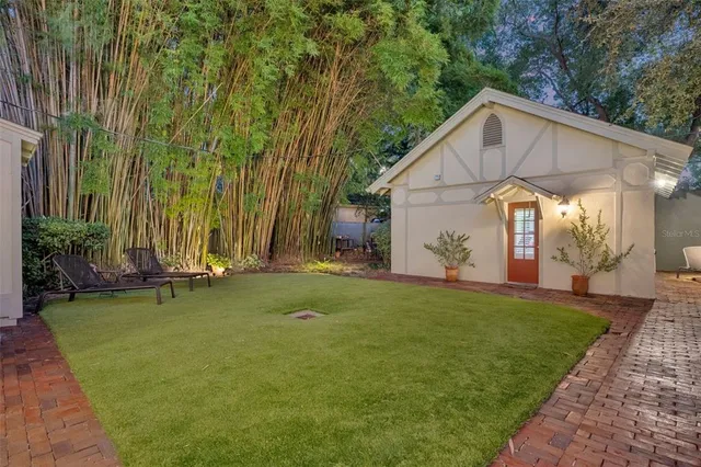 a backyard of a house with table and chairs