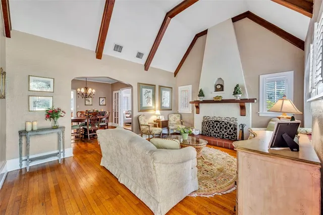 a living room with fireplace furniture and a wooden floor