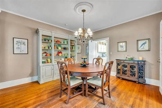 a view of a dining room with furniture and chandelier