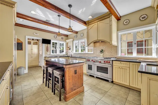 a kitchen with stainless steel appliances granite countertop a stove and a refrigerator