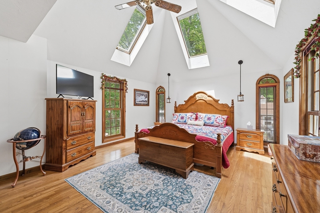 43 Flint Road Tyngsborough, MA 01879 - Photo 13 of 40 a bedroom with a bed and wooden floor