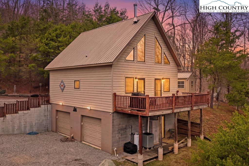 408 Eagle Ridge Road Roan Mountain, TN 37687 - Photo 45 of 45 a view of a house with a chairs and table in the patio