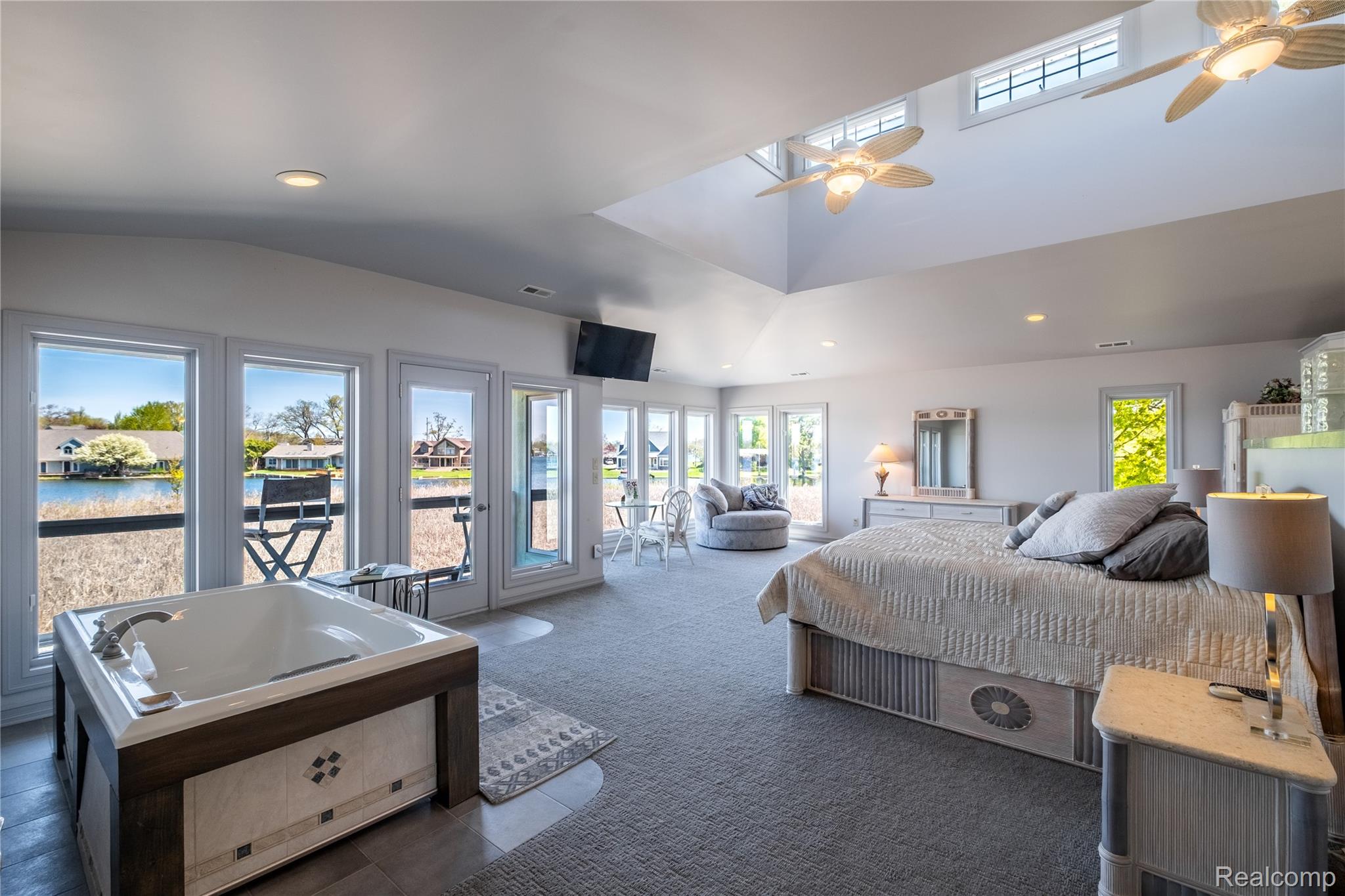 2350 Crane Road Fenton, MI 48430 - Photo 25 of 58 Bedroom with dark carpet, access to exterior, recessed lighting, dark tile patterned floors, and vaulted ceiling