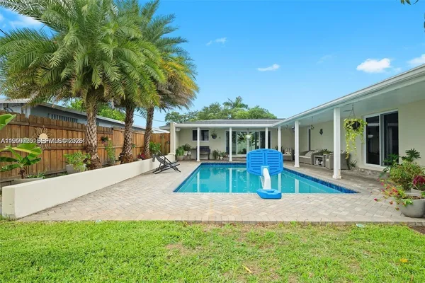 a view of house with outdoor space and swimming pool
