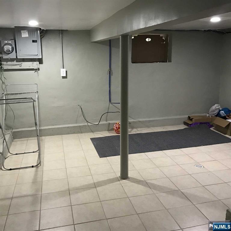 25 Kipp Street Newark, NJ 07108 - Photo 12 of 19 a view of a refrigerator in kitchen and an empty room
