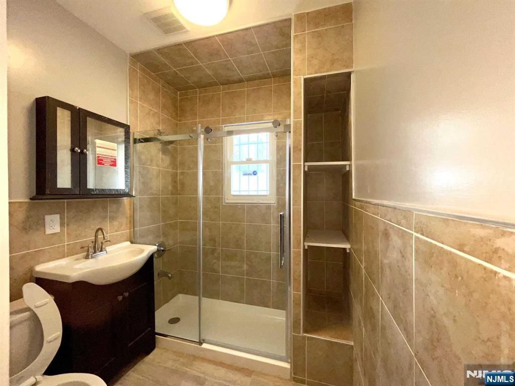 25 Kipp Street Newark, NJ 07108 - Photo 6 of 19 a bathroom with a sink and a mirror