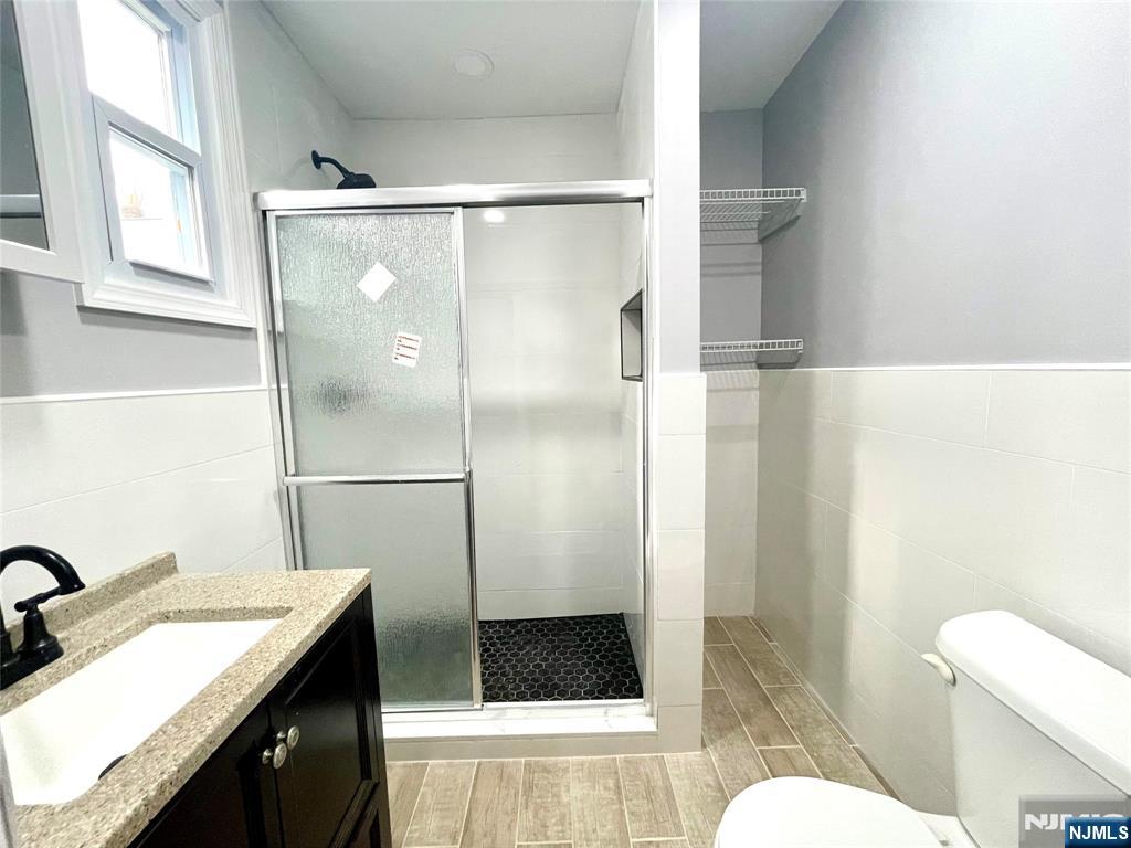 25 Kipp Street Newark, NJ 07108 - Photo 10 of 19 a bathroom with a granite countertop shower a sink and a toilet