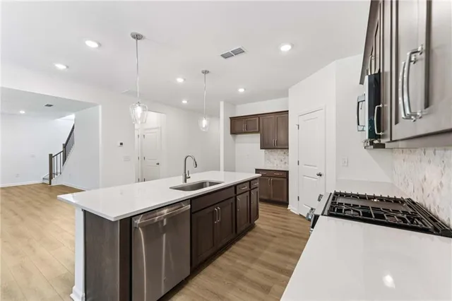 a kitchen with a sink a stove and a refrigerator