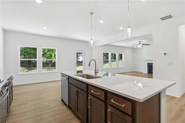 a kitchen with a sink a counter space and a refrigerator