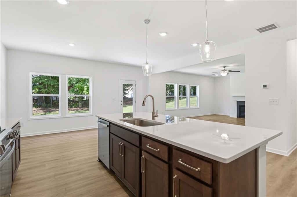 64 Silverleaf Trail Bethlehem, GA 30620 - Photo 16 of 44 a kitchen with a sink a counter space and a refrigerator