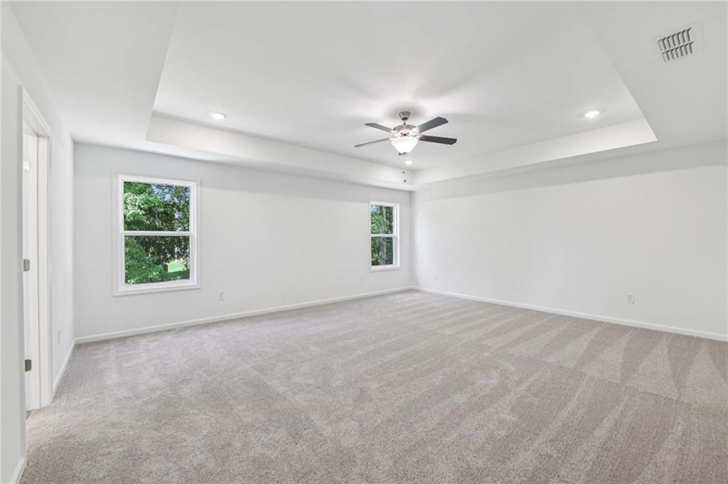 64 Silverleaf Trail Bethlehem, GA 30620 - Photo 20 of 44 an empty room with windows and fan