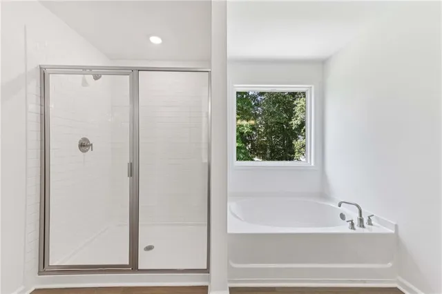 a bathroom with a bathtub and a shower