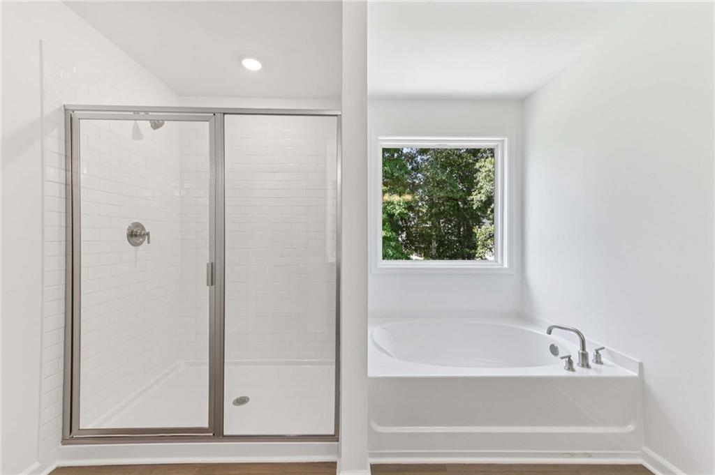 64 Silverleaf Trail Bethlehem, GA 30620 - Photo 23 of 44 a bathroom with a bathtub and a shower