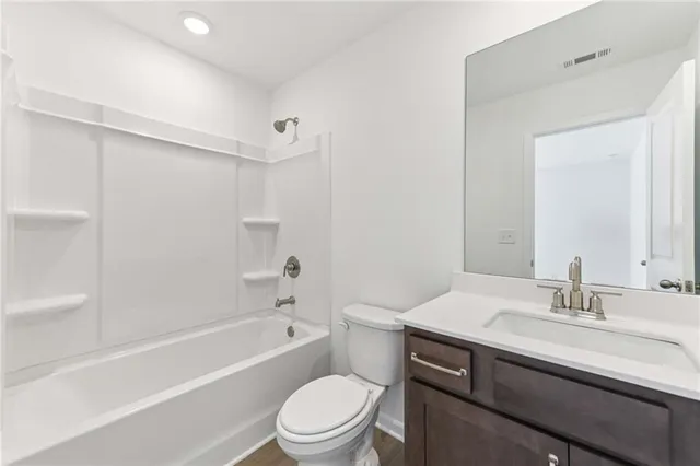 a bathroom with a sink a toilet and a bathtub