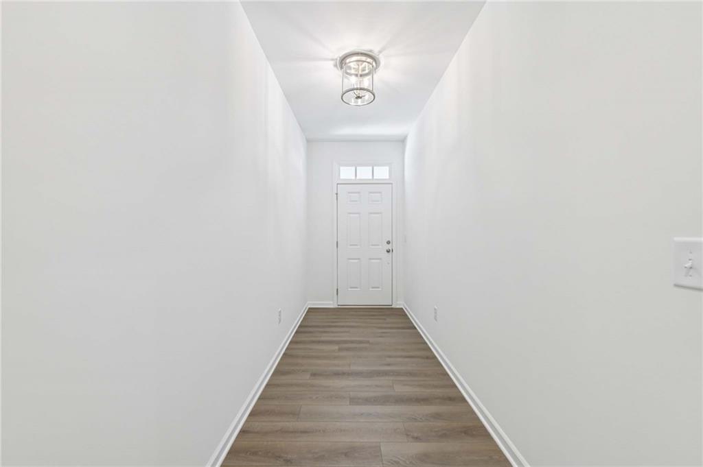 64 Silverleaf Trail Bethlehem, GA 30620 - Photo 3 of 44 a view of a hallway with wooden floor