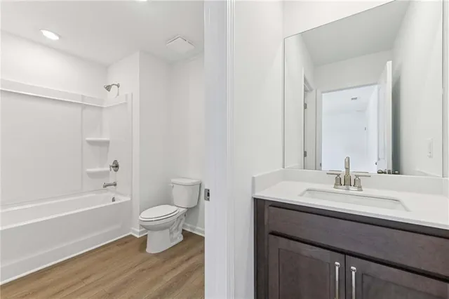 a bathroom with a sink toilet a mirror and shower