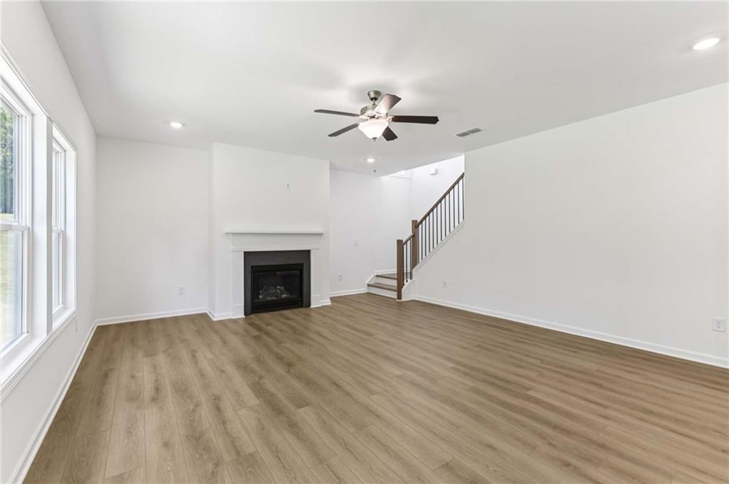 64 Silverleaf Trail Bethlehem, GA 30620 - Photo 6 of 44 wooden floor chandelier fan and windows in a room