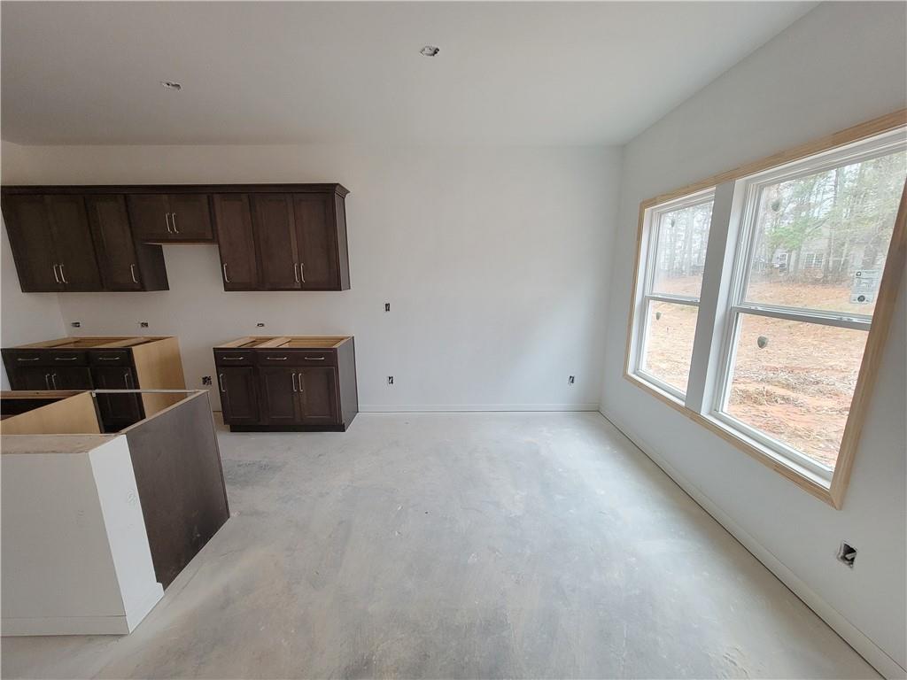 64 Silverleaf Trail Bethlehem, GA 30620 - Photo 8 of 25 a living room with furniture a flat screen tv and a fireplace