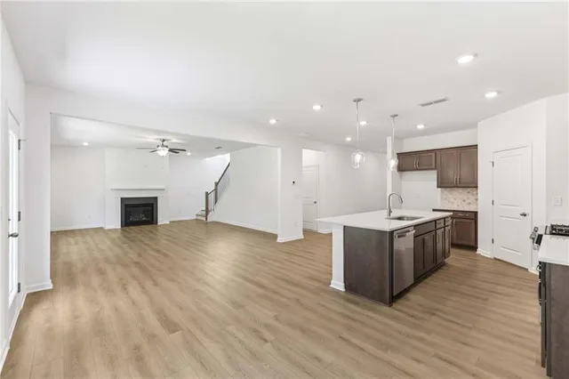 a large kitchen with a sink and a refrigerator
