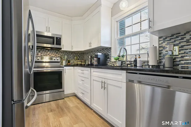 a kitchen with granite countertop a stove and a sink