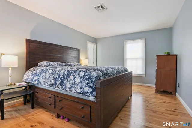 a living room with stainless steel appliances kitchen island sink refrigerator and stove