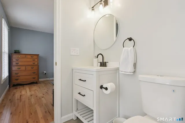 a bathroom with a sink mirror and vanity